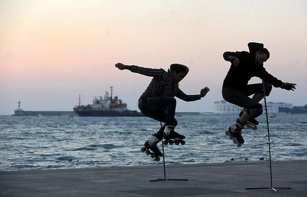 Two Skaters Jump on the Sevastopol Embankment