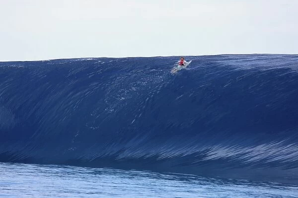 Tahiti - Surfing. Surfer at the top of a wave in Teahupoo