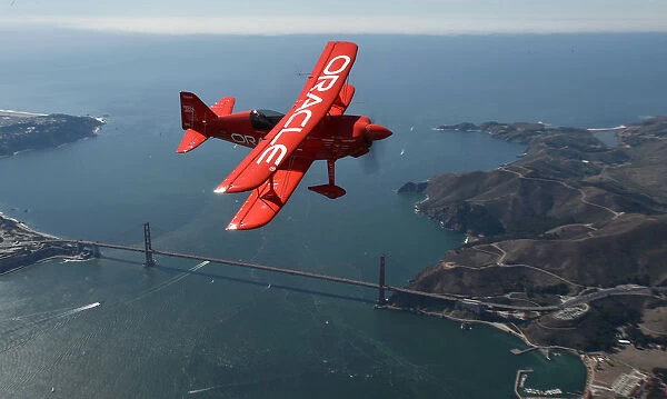 Team Oracle stunt pilot Sean Tucker flies over the Golden Gate bridge as part of