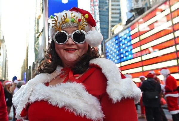 Us-Holiday-Santacon. Mrs. Claus poses for photos in Times Square as hundreds