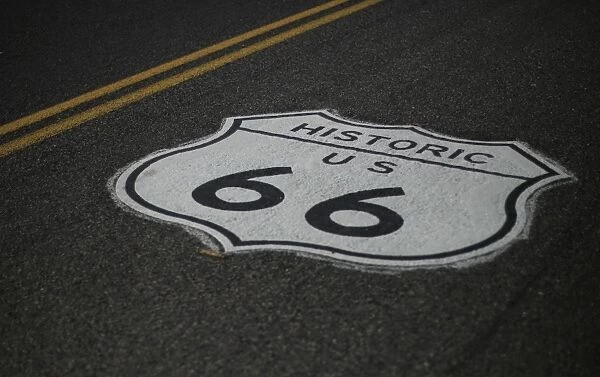 Us-Theme-Signs. A road marking of the historic Route 66 sign is seen painted