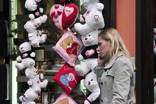 A woman walks past a shop selling love themed toys ahead of Valentine s