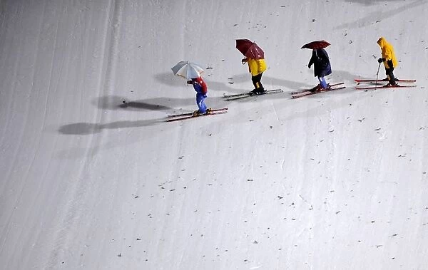Workers prepare the slope of the Large Hill individual ski jumping in the World Ski
