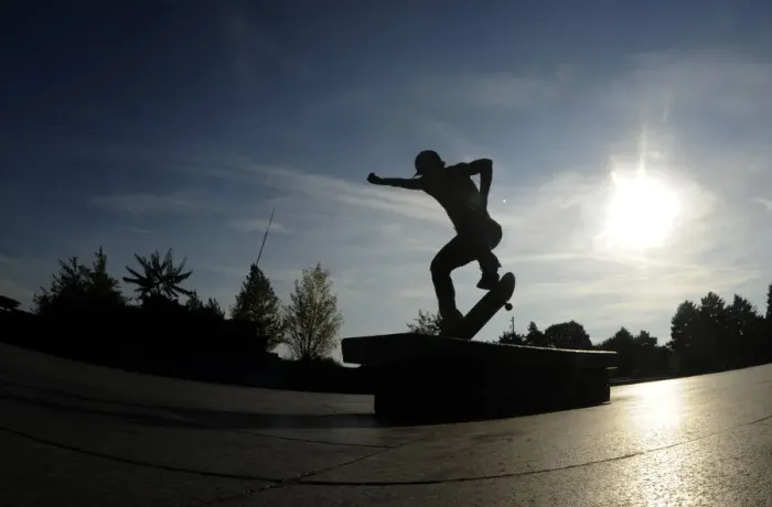 Framed Print : A youth performs a trick on his skateboard during a warm autumn sunny day on October 4 Framed Print : A youth performs a trick on his skateboard during a warm autumn sunny day on October 4