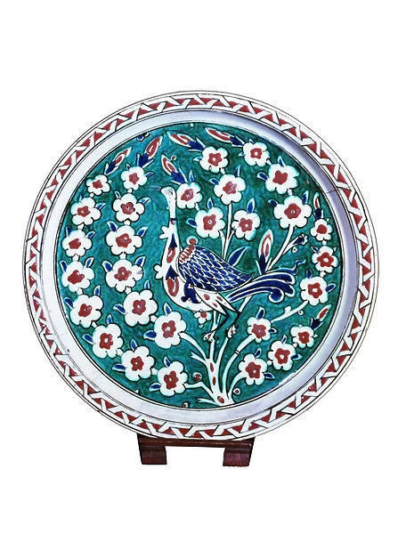 Peacock sitting on the branch of a wild rose bush (faience)