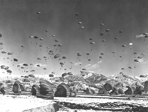 Men and equipment being parachuted over Korea