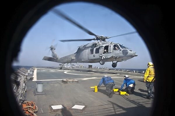 An MH-60S Sea Hawk takes off from the flight deck of USS Porter