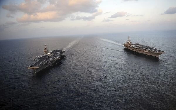 Nimitz-class aircraft carriers transit the Arabian Sea