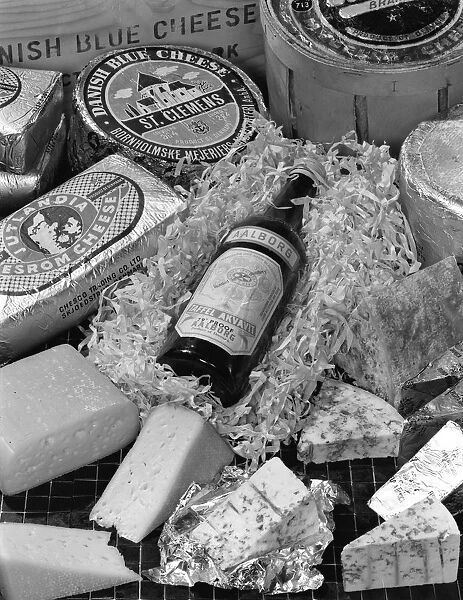 A selection of Danish cheeses and a bottle of Aalborg aquavit, 1963