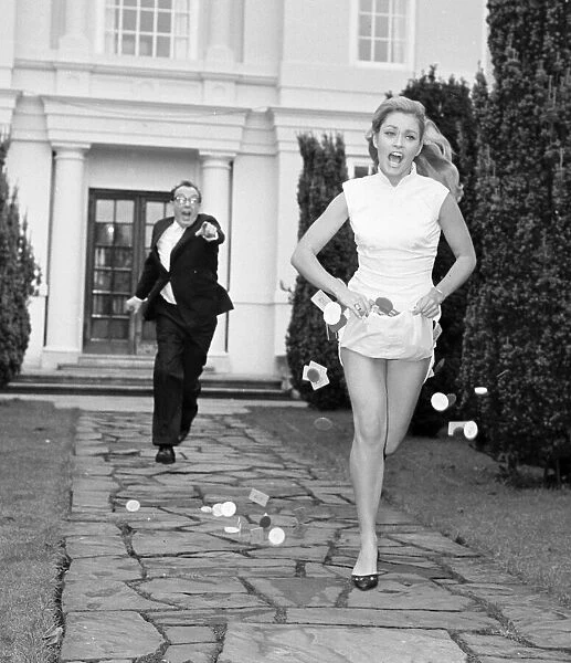 Actress Alexandra Bastedo seen here being chased by Eric Morecombe whilst filming a