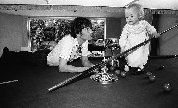 Alex Higgins World Snooker Champion 1982 with his daughter Lauren as she tries to