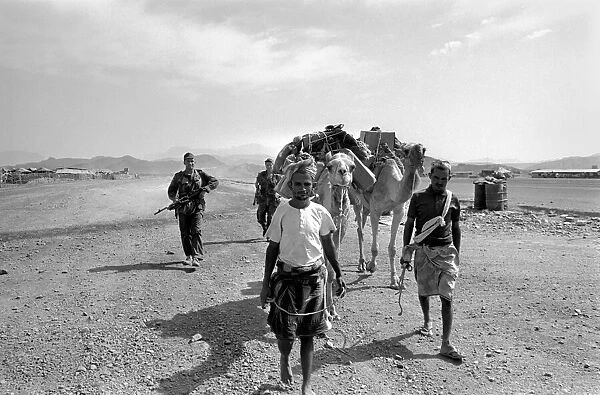 British Army in Aden with locals and a camel. April 1966 W4001b-006