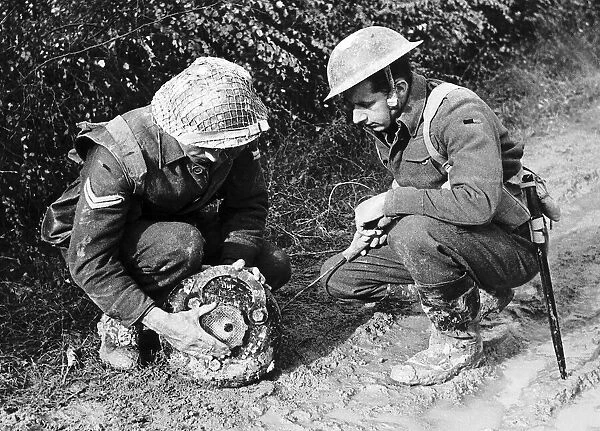 British soldiers defusing a land mine during WW2. 1944