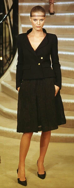 Eva Herzigova wearing Chanel 20 January 1998: wearing hair net and black suit