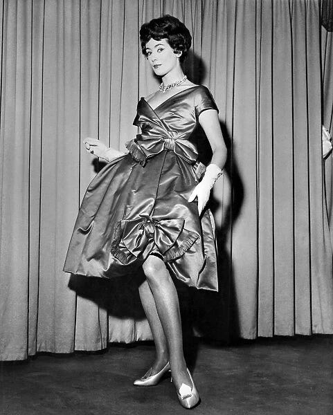 Pat O Reilly modeling a short evening dress called 'Amour'