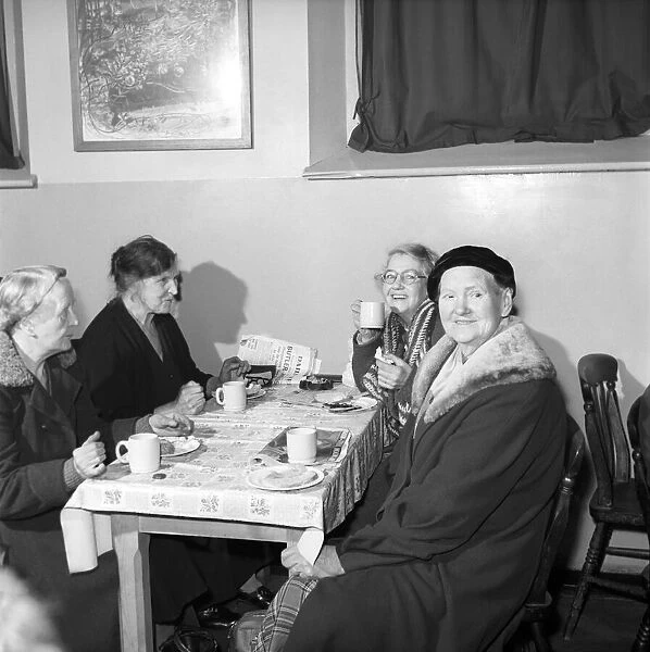 Women chat, share a cup of tea and read the newspapers at a womens lodging house