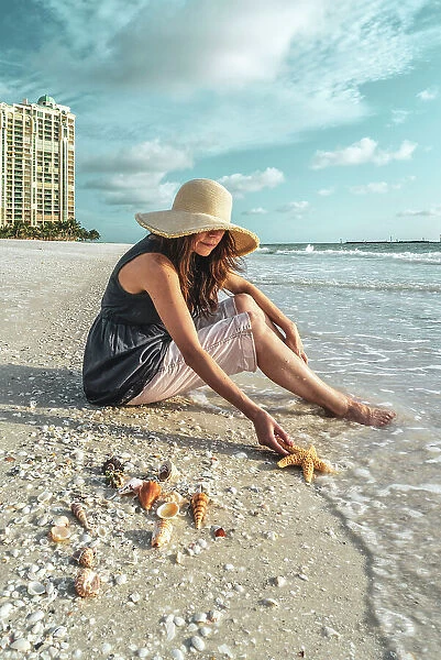 Florida, Marco Island, Beach, woman holding starfish