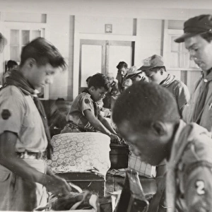 Boy scouts at camp, packing up, British Honduras