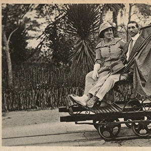 Couple riding trolley, Beira, Mozambique, East Africa