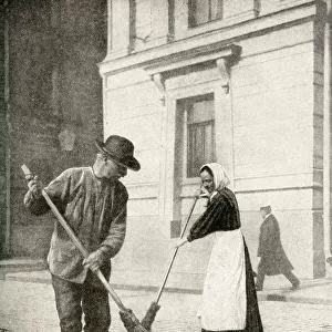Couple sweeping a street, Helsingfors, Finland