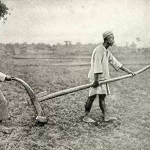 Malay man and woman tilling field, South East Asia