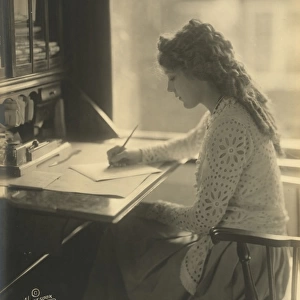 Mary Pickford writing at a desk