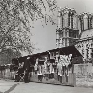 Print seller and customer near Notre Dame, Paris, France