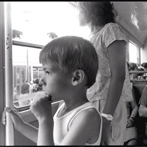 Small boy lady with fan on bus, Valencia, Spain
