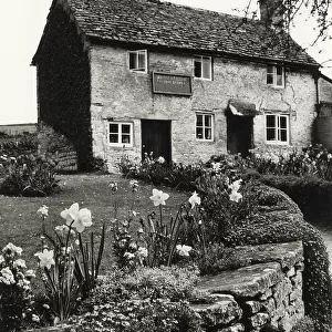 The village grocery store, in an old cottage at Daglingworth, Gloucestershire, England. Date: 1960s
