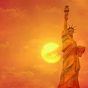 Sunset behind the Statue of Liberty