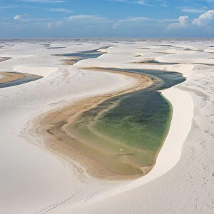 Aerial of freshwater lakes between huge sand dunes in the Lencois Maranhenses National Park, Maranhao, Brazil, South America