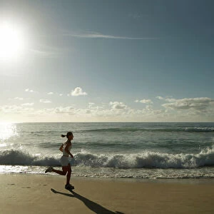 Early morning female runner, Bondi beach, Sydney, New South Wales, Australia, Pacific