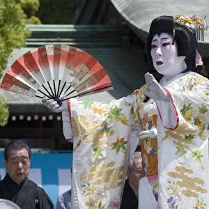 Man dressed as a woman performing classical Japanese dance called hobu at Meiji Jingu shrine