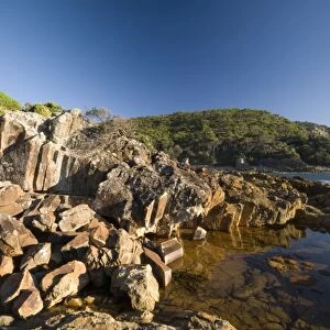 Mimosa rocks and rock pool in natural bay composed of volcanic Rhyolite rock