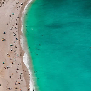 Myrtos beach panorama with crystal clear waters and unidentifiable bathers, Kefalonia island, Greek Islands, Greece, Europe