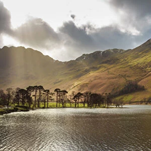 Shafts of light break through clouds to illuminate the fells in winter, Buttermere