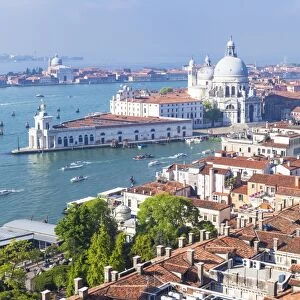 Vaporettos (water taxis), rooftops and the church of Santa Maria della Salute, on the Grand Canal