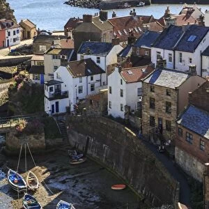 Winding alleys of village, fishing boats and sea, elevated view in summer, Staithes