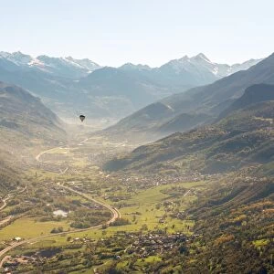 hot air balloon flies over Aosta city, Valle d Aosta, Italy, Europe