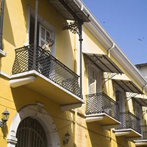 Panama, Panama City, Woman standing on balcony in Casco Viejo (San Felipe)