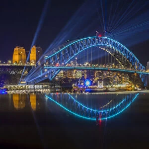 Sydney Harbour Bridge illumiated with coloured lights and lasers during Sydney Solstice