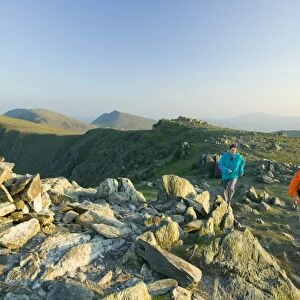 A man and women fell running on Great Carrs in the Lake District UK