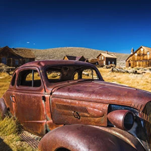 Rusted car and buildings, Bodie State Historic Park, California USA