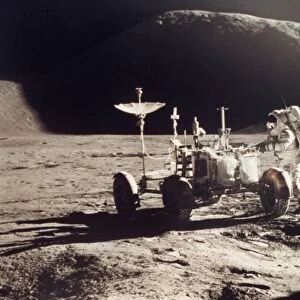 APOLLO 15, 1971. Jim Irwin standing by the lunar rover, Mount Hadley in the background
