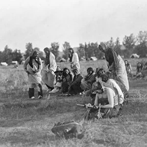 CHEYENNE SUN DANCE, c1910. Group of Cheyenne men and women passing a pipe during