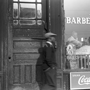 CHICAGO: BARBER SHOP, 1941. A barbershop in the Black Belt section of Chicago, Illinois. Photograph by Edwin Rosskam, April 1941