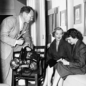 MARILYN MONROE (1926-1962). American cinema actress. Monroe in her dressing room at Fox Studios with journalist Aline Mosby and photographer George Long, 1952