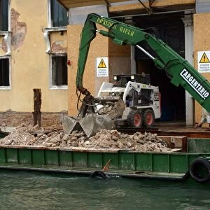 Barge with rubble on canal, Venice, Italy
