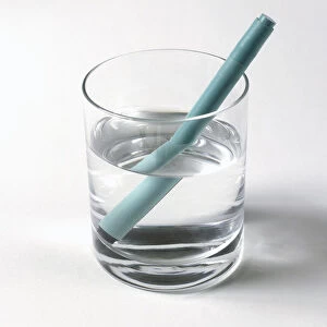 Felt tip pen in glass of water, appearing to be bent