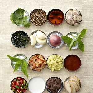 Herbs, spices, oils, pastes and vegetables in bowls